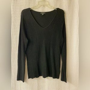 Long sleeved, stretchy shirt. Neckline- V-neck. Color- Black and shimmery.
